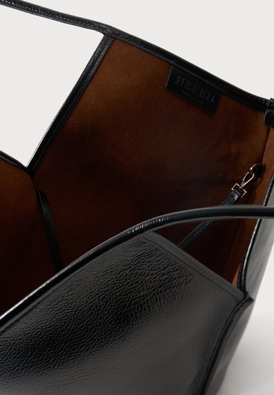 Μαύρη δερμάτινη τσάντα με υφή πέτρας, καφέ σουέντ εσωτερικό, λεπτό λουράκι ώμου και προσαρτημένη μικρή μαύρη τσάντα με ασημί κλείστρο.