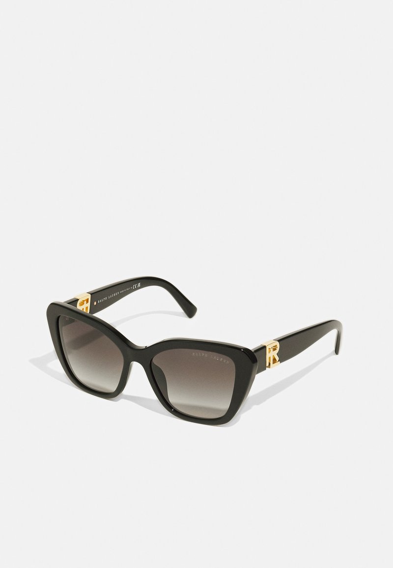 Black cat-eye sunglasses with gradient lenses. Features gold hardware accents on temples. Smooth plastic frame with a glossy finish.