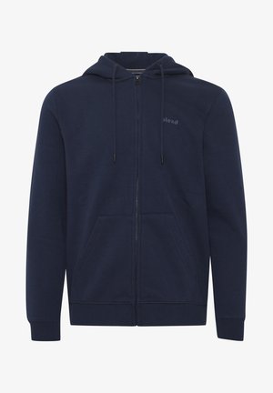 Navy sinikainen vetoketjullinen huppari, joka on valmistettu puuvillasekoitteesta. Hupparissa on kiristettävä hattu, kaksi etutaskua ja pieni logo rinnassa.