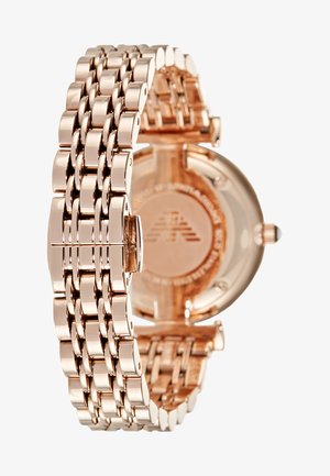 Rose gold metal watch with a linked bracelet design. Smooth, polished surfaces and rounded case. Back features manufacturer engraving.
