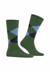 Calze verdi con un motivo argyle blu, verde scuro e nero. Il dettaglio include cuciture rosse lungo le forme a diamante.