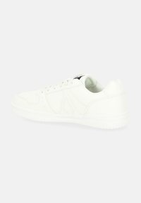 White sneaker with a smooth synthetic upper, lace-up design, padded collar, and a rubber outsole featuring subtle tread patterns.