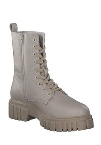 Beiger Stiefelette aus Kunstleder mit grober, strukturierter Sohle, Schnürung vorne und seitlichem Reißverschluss für einfachen Zugang.