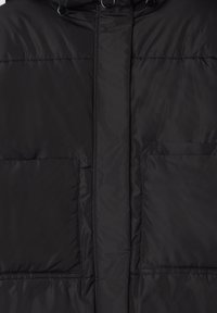 Czarna kurtka puchowa o gładkim, błyszczącym wykończeniu. Posiada dwie duże przednie kieszenie oraz wysoki kołnierz, zapięcie na zamek błyskawiczny oraz akcenty w postaci guzików.