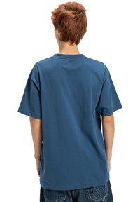 Blue cotton t-shirt, relaxed fit, short sleeves, crew neck, smooth texture, with a plain back and no visible logos or patterns.