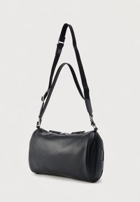 Black leather shoulder bag with a cylindrical shape, adjustable fabric strap, silver hardware, and zip closure on top. Smooth texture.