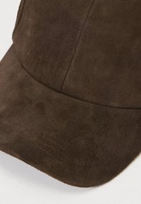 Bruine suède pet met een afgeronde kroon en gebogen klep, voorzien van subtiele stiklijnen en een gladde, gestructureerde oppervlakte.