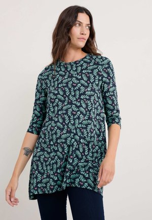 Langärmlige Tunika in Marineblau mit grünem Blattmuster und lila Akzenten, aus weichem Stoff gefertigt, mit lässiger Passform und seitlichen Schlitzen.
