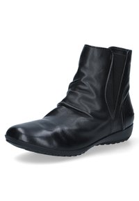 Bottine en cuir noir avec un design ample, panneaux latéraux élastiques, bout arrondi et semelle en caoutchouc texturé. Fini lisse.
