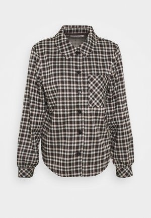 Camicia a bottoni in un motivo a quadri bianco e nero, maniche lunghe, colletto a punta e una tasca sul petto. Realizzata in un tessuto morbido e testurizzato.