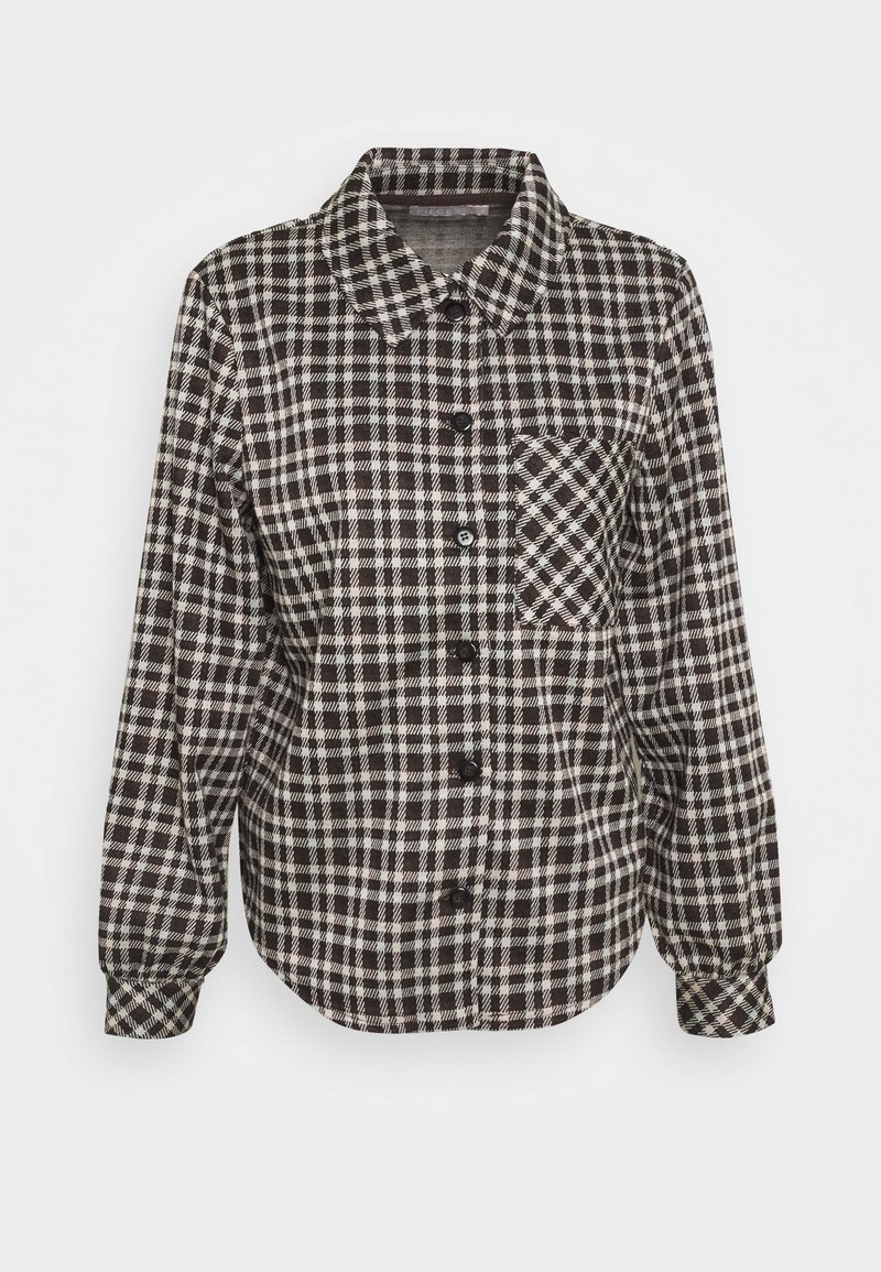 Camicia a bottoni in un motivo a quadri bianco e nero, maniche lunghe, colletto a punta e una tasca sul petto. Realizzata in un tessuto morbido e testurizzato.