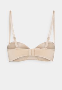 Beige underwire bra with a smooth texture, adjustable straps, and a hook-and-eye closure at the back. Simple design, lightweight material.