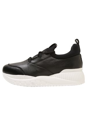 Baskets en cuir noir texturé avec semelle blanche épaisse, design slip-on, lacets élastiques noirs et languette au talon.