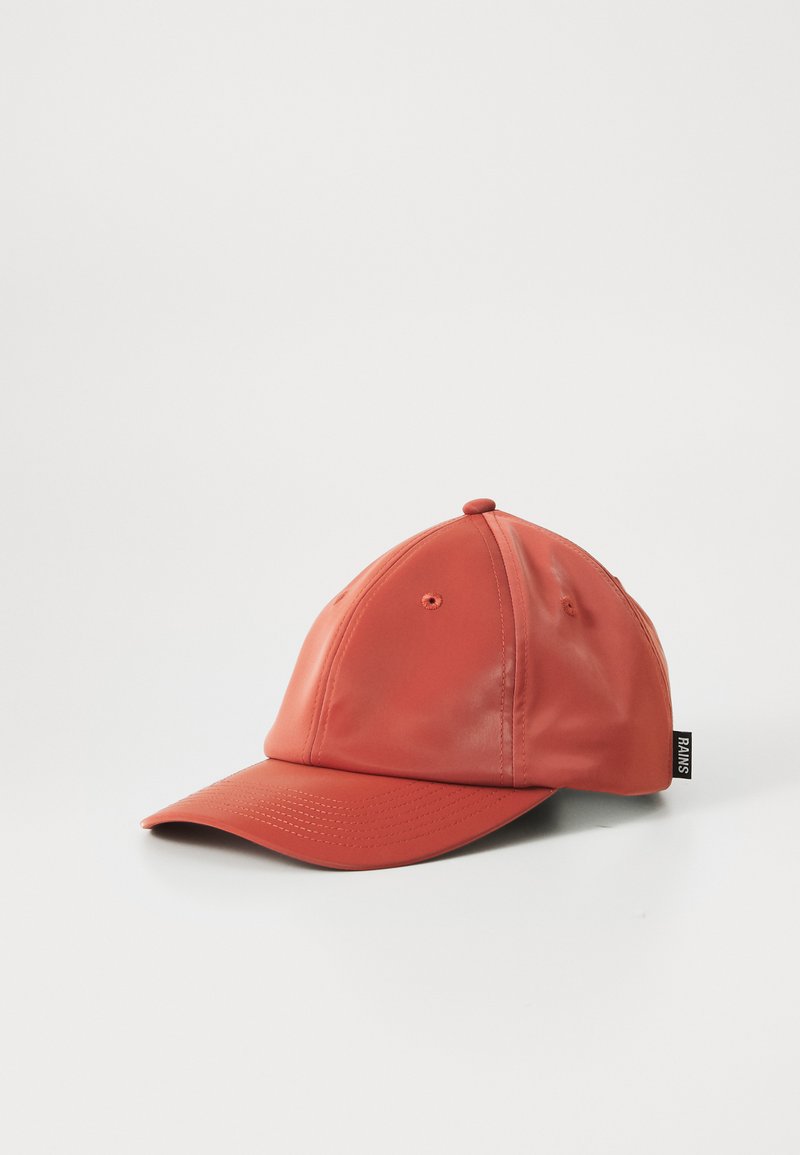 Casquette de baseball rouge vif avec une finition brillante, dotée de trous de ventilation et d'une étiquette noire, présentée sur un fond blanc uni.