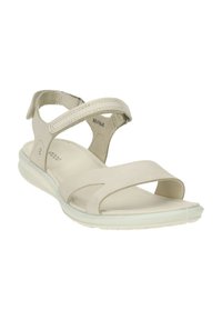 Sandal beige chiaro realizzato in materiale morbido e liscio, dotato di fasce regolabili, design a punta aperta e suola flessibile e imbottita.