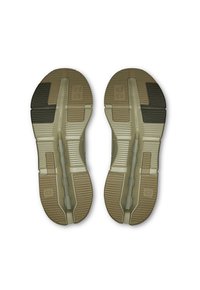 Suelas de zapatos en beige y marrón con patrones texturizados, que presentan ranuras para tracción y un detalle de logo en un lado.