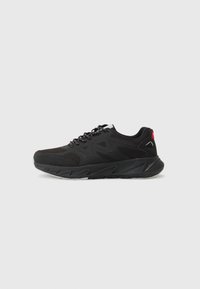 Black athletic shoe features a mesh upper with synthetic overlays, a cushioned sole, and contrasting red accents on the heel.