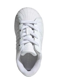 White sneaker with a textured shell toe, smooth upper, lace closure, and padded collar. Features embossed branding on the tongue and insole.