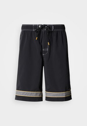 Zwarte zwemshort met een taillekoord, contrasterende witte stiksels en gele accenten bij de zoom, gemaakt van een glad, lichtgewicht materiaal.