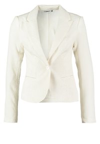 Blazer blanc texturé à manches longues, fermeture à un bouton, revers crantés et poches latérales. Le tissu présente un motif discret en relief.