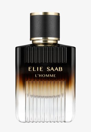 Flacon de parfum en verre côtelé avec un dégradé noir à clair, étiqueté "ELIE SAAB L'HOMME" avec un capuchon cylindrique noir et or.