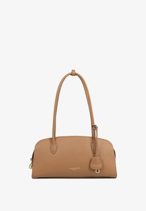 Tan leather handbag with a streamlined shape, double handles, and a decorative hanging tag featuring gold hardware and branding.