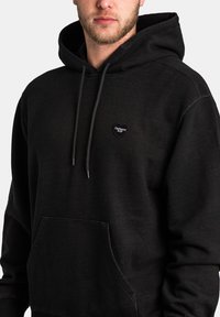 Black hoodie made of cotton blend, featuring a kangaroo pocket, drawstring hood, and a heart-shaped logo on the left chest.
