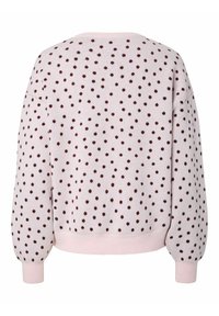 Sweat-shirt rose clair à pois marron foncé, poignets et ourlet côtelés, coupe décontractée et col rond. Texture douce et tricotée.