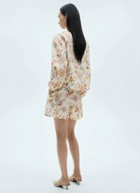 Floral patterned dress with long sleeves, soft fabric, light colors featuring pink, blue, and orange. Includes a short hem and relaxed fit.
