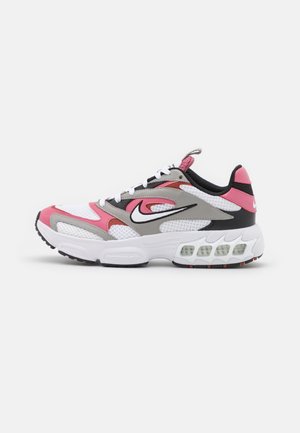 White, pink, gray, and black Nike running shoe with visible air cushion sole and white laces, shown from the side on a plain background.
