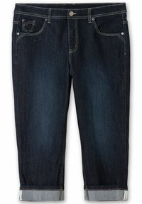 Tmavě modré džíny s rovnými nohavicemi, ohrnutými manžetami a zlatým prošíváním na kapsách a švech. Obsahují knoflíkové zapínání a zip.