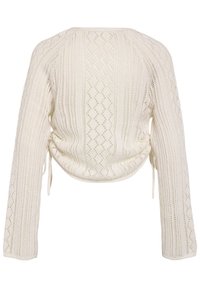 Pull tricoté couleur crème avec manches longues, motifs en losanges et ajourés verticaux, avec liens sur les côtés, vu de dos.