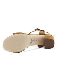 Brown suede high-heeled sandal with a block heel, adjustable ankle strap, and textured sole showing size and brand markings.