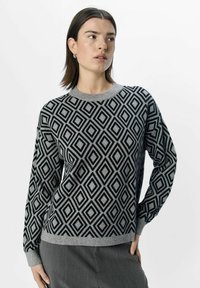 Schwarzer und grauer pullover mit Rautenmuster, Rundhalsausschnitt und langen Ärmeln, aus weichem Strickmaterial. Mit gerippten Bündchen und Saum.