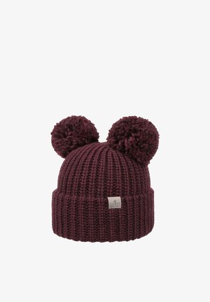 Burgundy knitted beanie with two large pom-poms on top and a small rectangular fabric label on the cuff.
