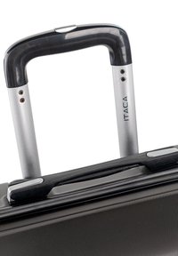 Mango extensible de maleta de trolley con agarre de plástico negro y varillas telescópicas plateadas, unido a un cuerpo de equipaje texturizado de color gris oscuro.