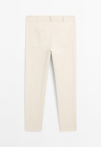 Beige pants with a slim fit, featuring two back pockets, smooth texture, and a mid-rise waistband, displayed from the back.