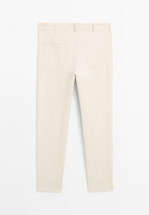 Beige pants with a slim fit, featuring two back pockets, smooth texture, and a mid-rise waistband, displayed from the back.
