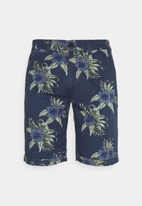 Tummansiniset shortsit, jotka on valmistettu kukkakuosisesta kankaasta purppuran ja vihreän sävyissä. Hameen reunoissa on käänteet.