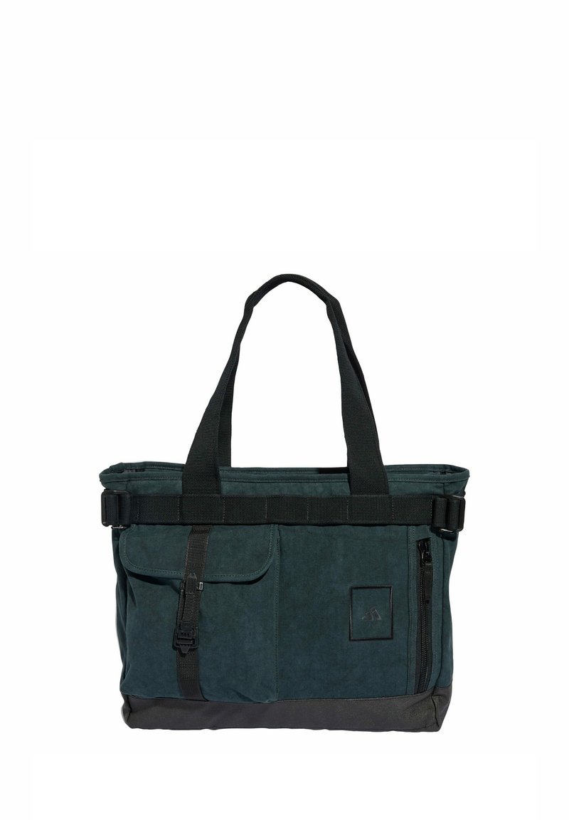 Dark green, canvas tote bag with dual handles, a black strap, front pockets, and a zipper closure; features a textured surface.