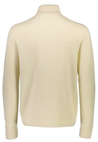 Suéter de punto ribeteado en color crema, con un cuello alto, mangas largas y un dobladillo recto. La textura parece suave y ligera.