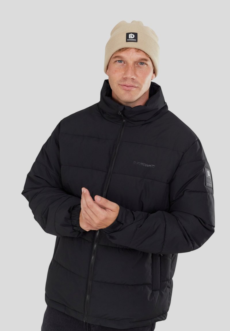 Doudoune noire avec fermeture éclair, col haut, poignets élastiques et un patch logo sur la manche gauche. Design texturé et rembourré pour la chaleur.