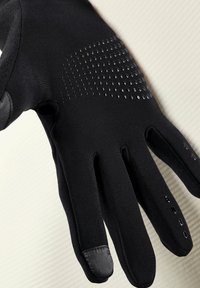 Black gloves made of stretchy fabric, featuring textured grip dots on the back and smooth accents on the fingertips and wrist area.