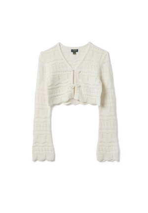 Cardigan court blanc en maille avec manches longues, col en V, bords festonnés et deux fermetures à nouer sur le devant.