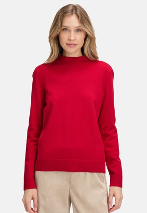 Roter Pullover mit langen Ärmeln, hohem Kragen, gerippten Bündchen und Saum. Sanfte Textur und einfarbig ohne Muster oder Verzierungen.