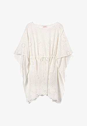 Blouse en dentelle œillet blanche avec taille à cordon, larges manches volantes et ourlet festonné pour un look aérien et féminin.