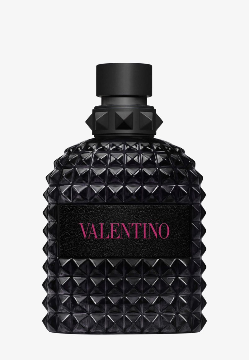 Black studded glass perfume bottle with a square cap and a black label reading Valentino in pink letters.