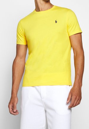 Yellow short-sleeve t-shirt with a crew neck and a small embroidered logo on the chest. Smooth cotton fabric, fitted design.