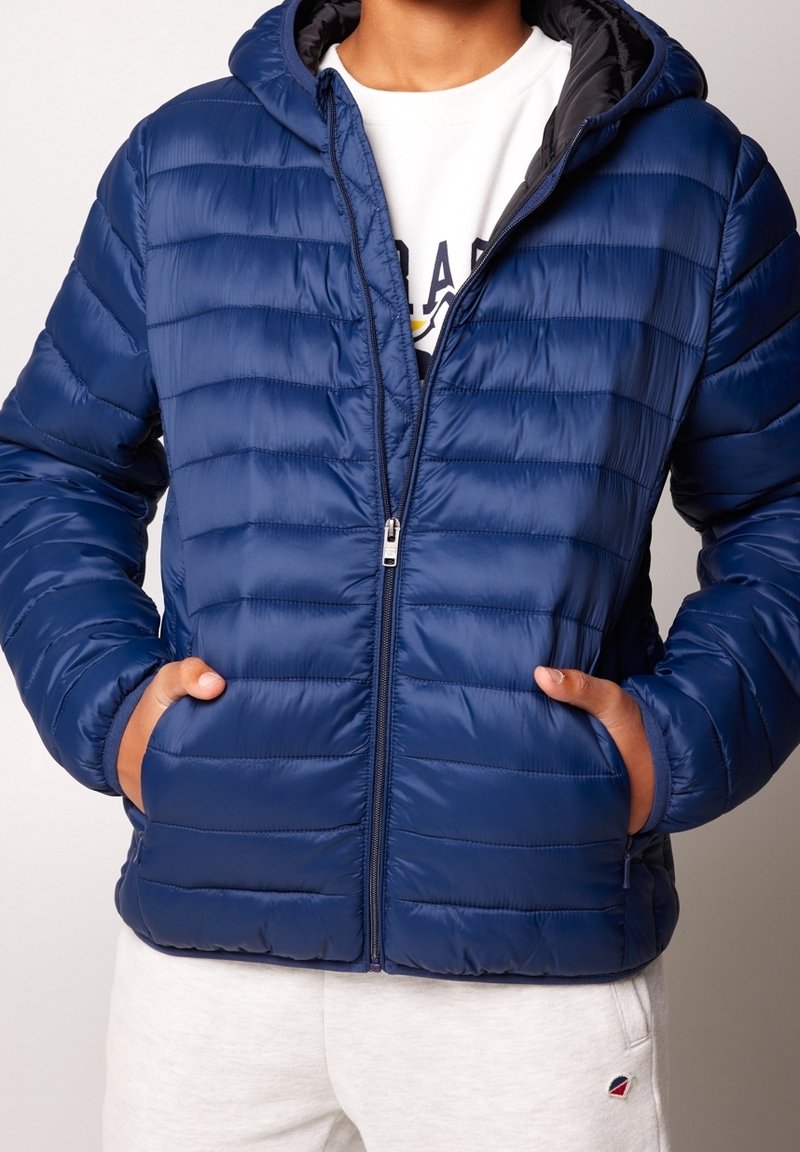 Navy puffer jacket with a quilted design, hood, and zipper front. Features two side pockets and sleek, smooth texture.