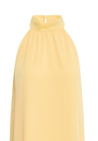 Haut jaune sans manches avec col montant et fermeture par bouton en forme de trou à l'arrière, en tissu léger.